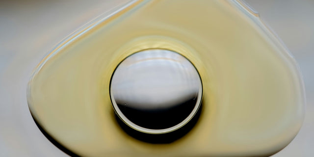 Golden droplet surrounded by a thin outer layer, illustrating how LipiSperse® coats each HydroCurc® curcumin particle