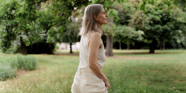 Woman walking outdoors, representing weeks 1-2 of AEVUM Daily Vitals — first signals emerge
